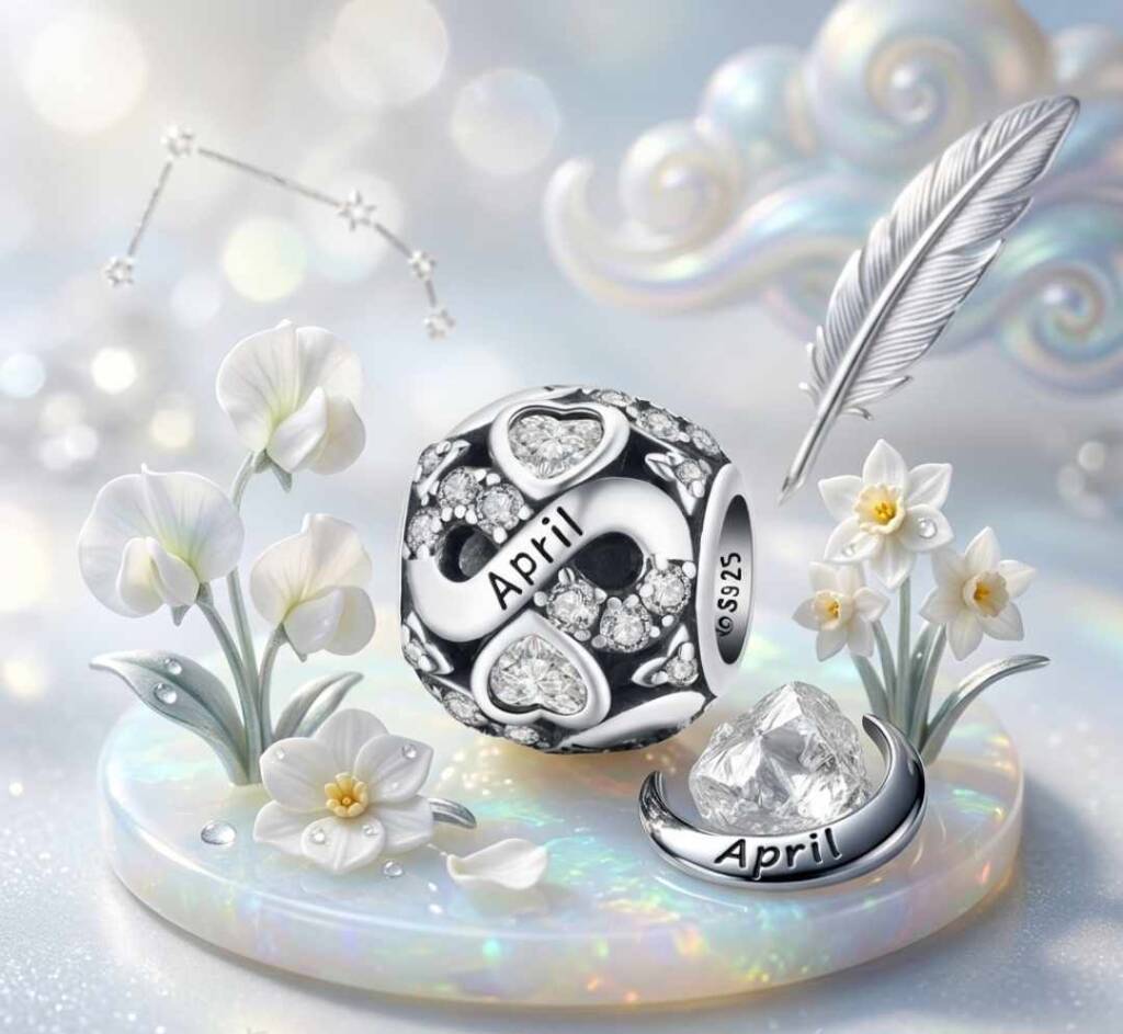 Родените през април: Пролетен огън и инат, който мести планини! Близък план на сребърен талисман със знака S925 и надпис April, заобиколен от нежни рисувани пролетни цветя, подчертаващ фината изработка и качеството на бижуто за родените през април.